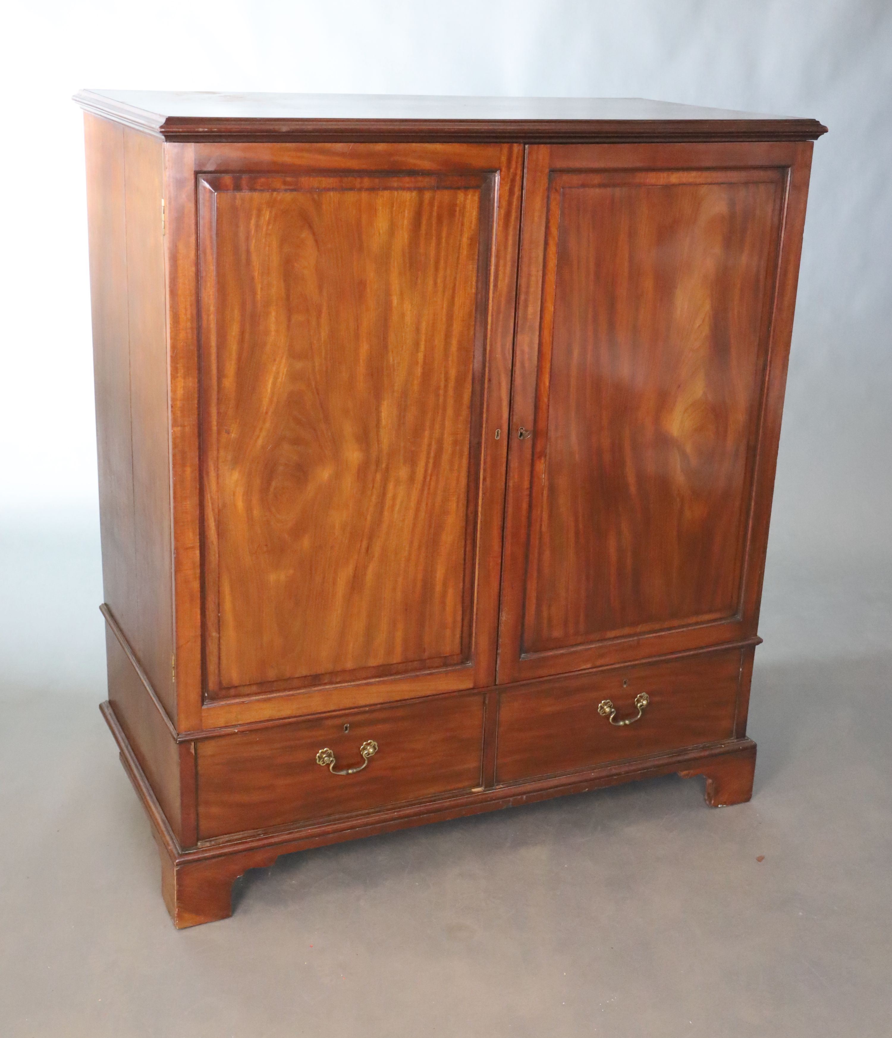 A George III mahogany press cupboard, W.127.5cm D.66cm H.145cm